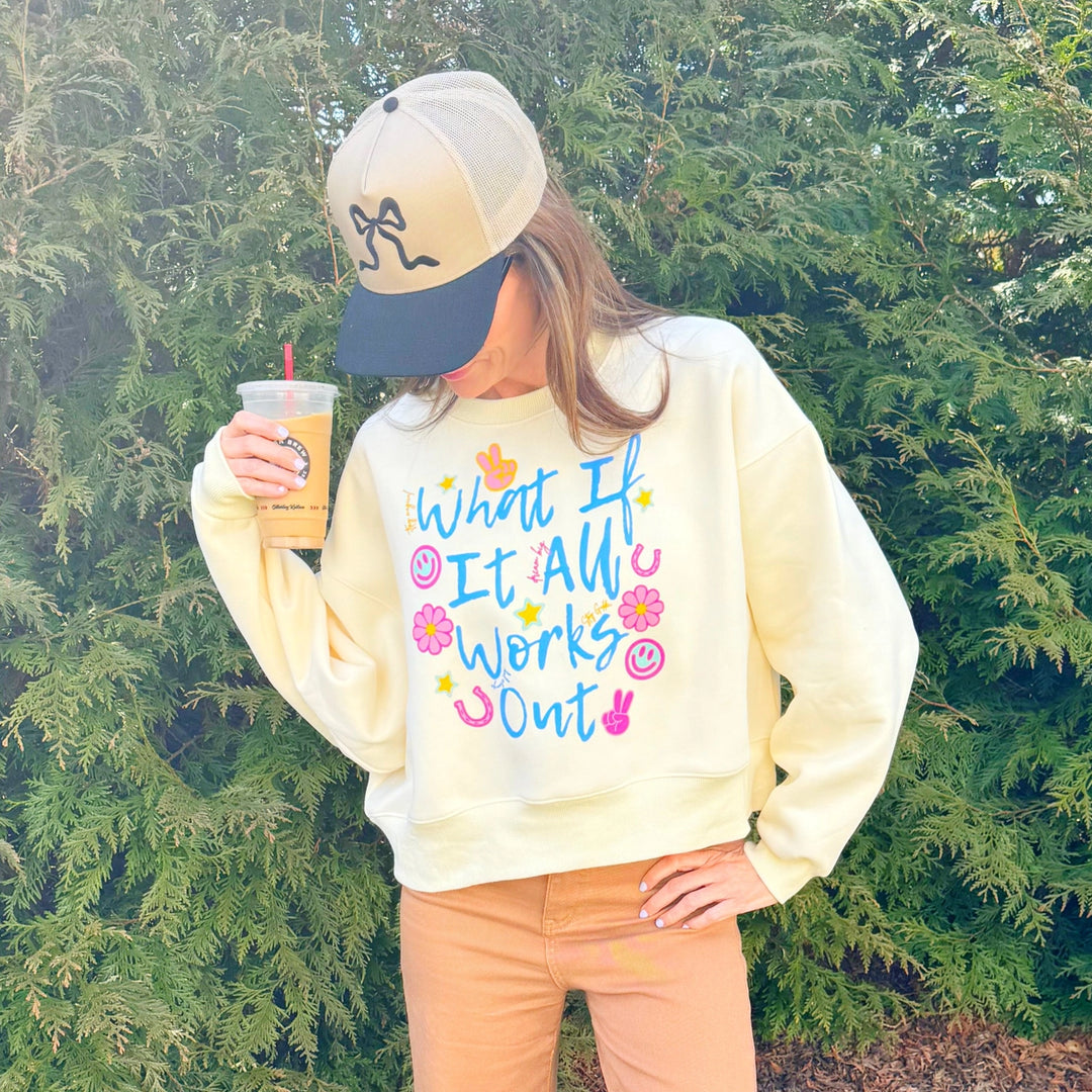 Woman wearing graphic sweatshirt in front of tree