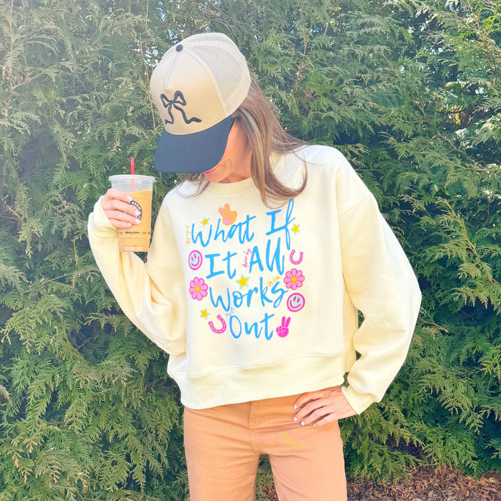 Woman wearing graphic sweatshirt in front of tree