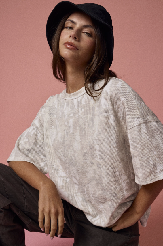 Woman wearing camo tee on plain background