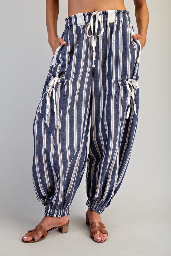 Woman wearing blue stripe pants on plain background