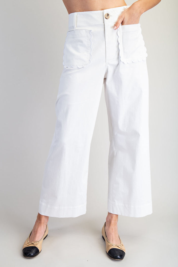 White wide-leg pants worn by a person on a plain background
