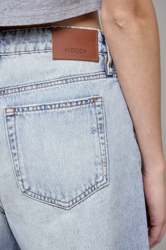 Light blue jeans with a brown leather patch and &