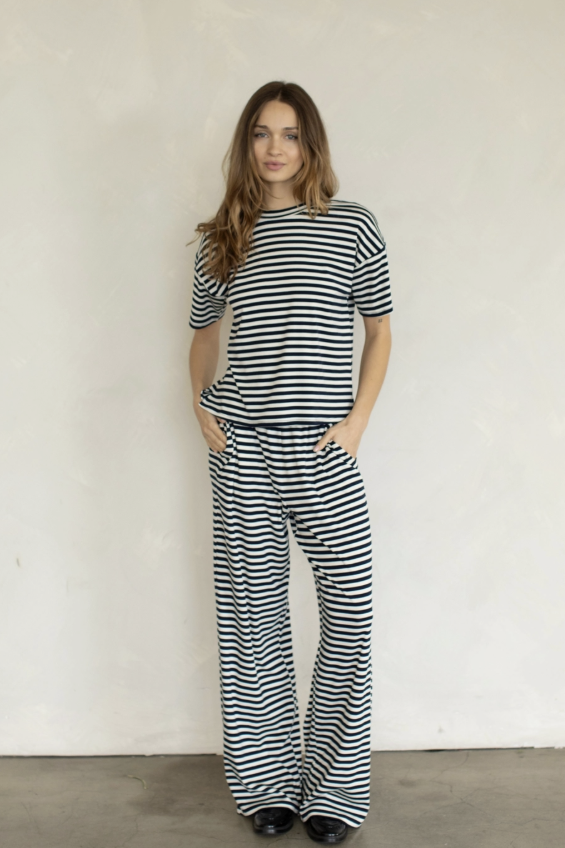 Woman wearing midnight blue and white stripe set on plain background