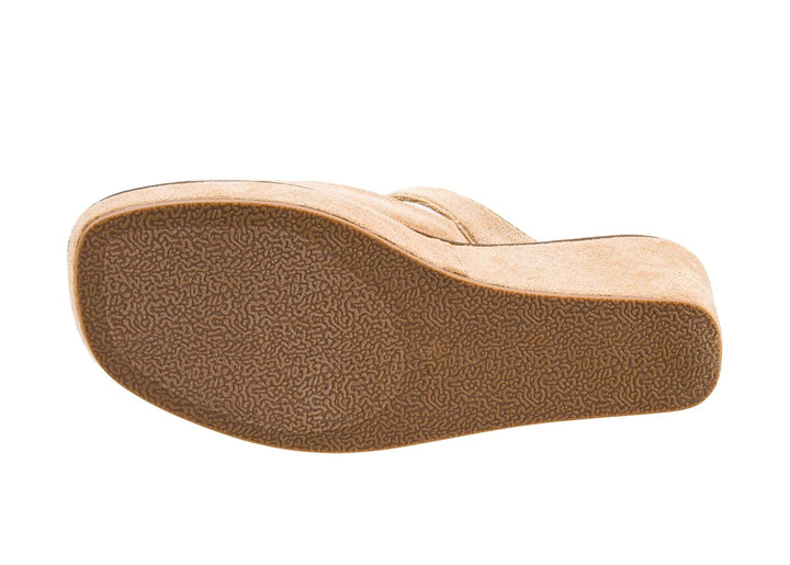 Bottom of suede wedge shoe on white background