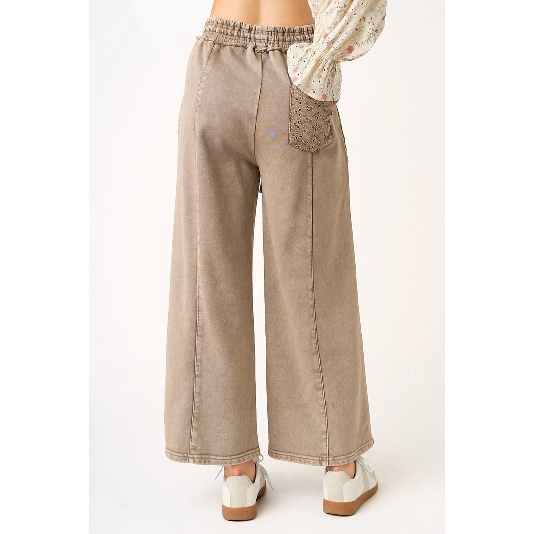 Beige wide-leg pants worn by a person on a white background