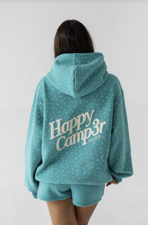 Person wearing a teal hoodie with &
