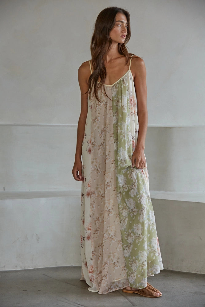 Woman wearing floral print dress on plain background