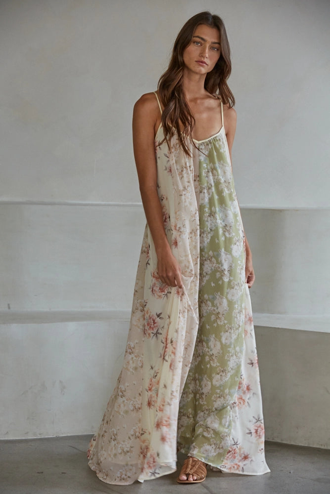 Woman wearing floral print maxi dress on plain background