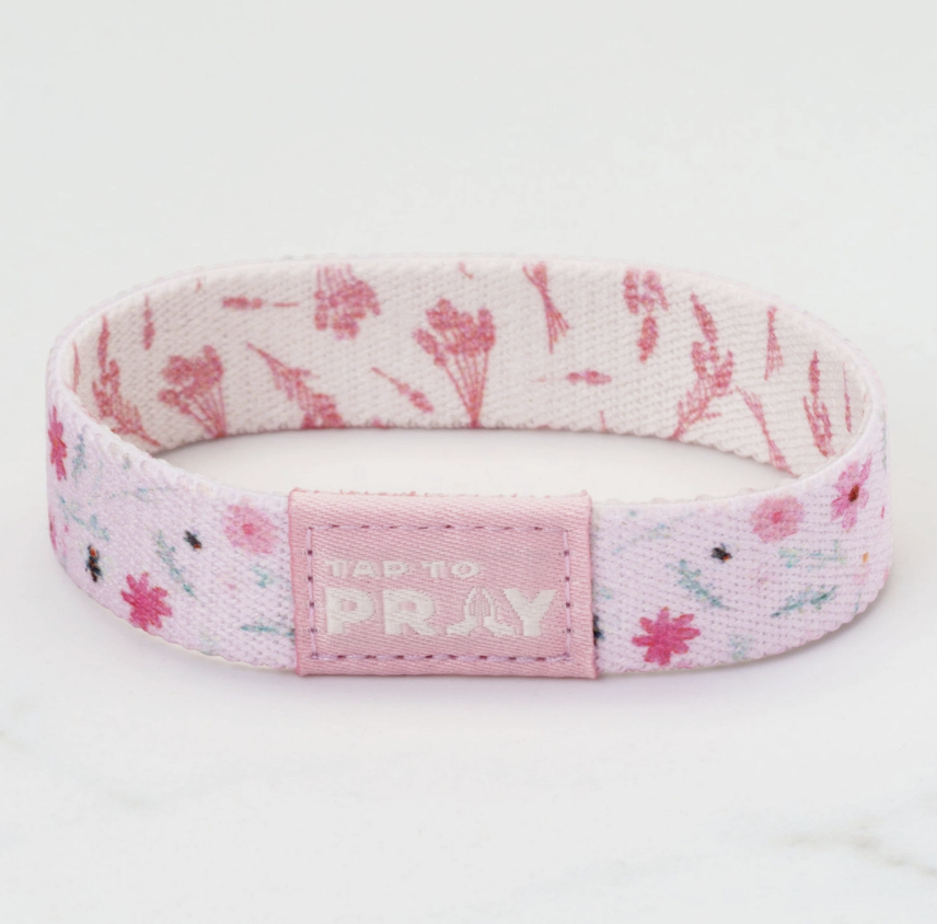 Floral patterned bracelet with 'Tap to Pray' tag on a white background