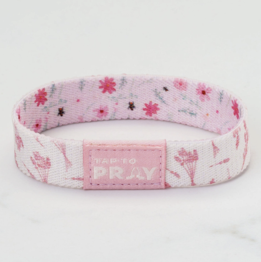 Pink and white wristband with floral pattern and &