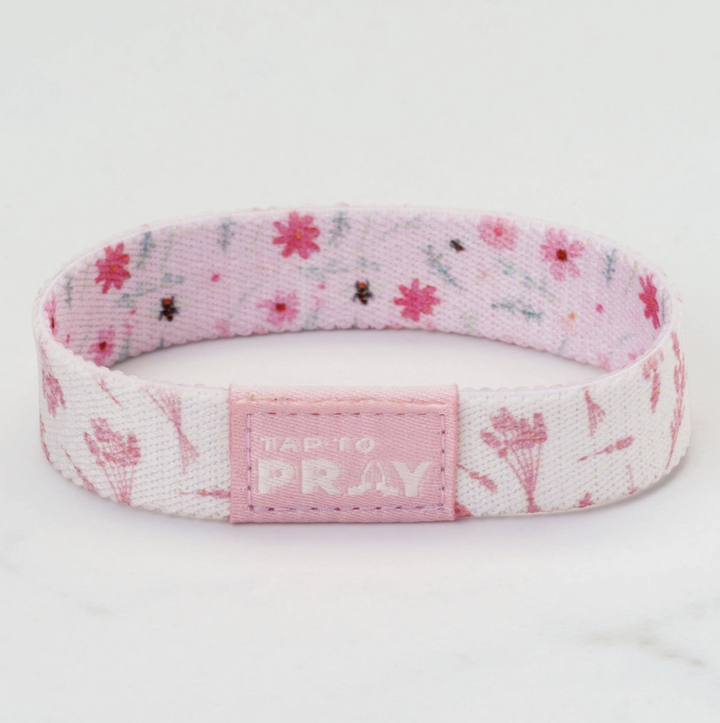 Pink and white wristband with floral pattern and &