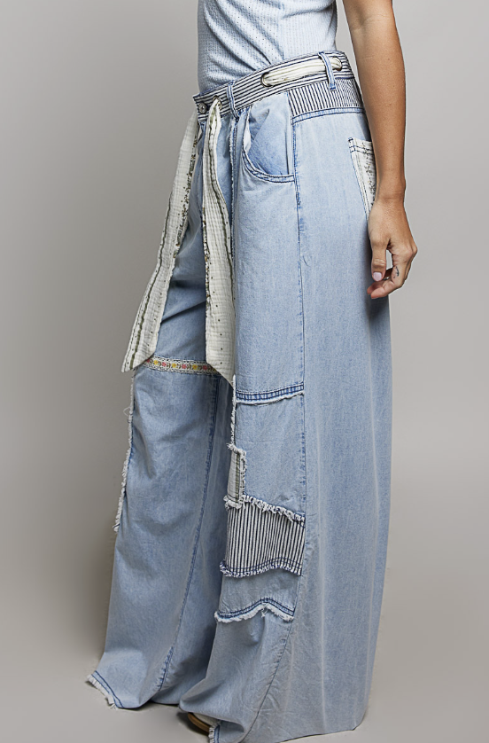 Long denim pants with a unique design on a gray background