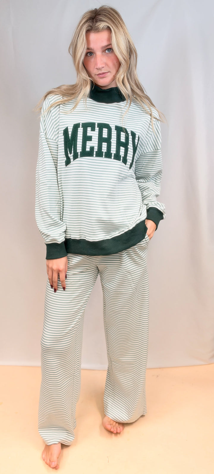 Woman wearing matching sage and ivory stripe set with &