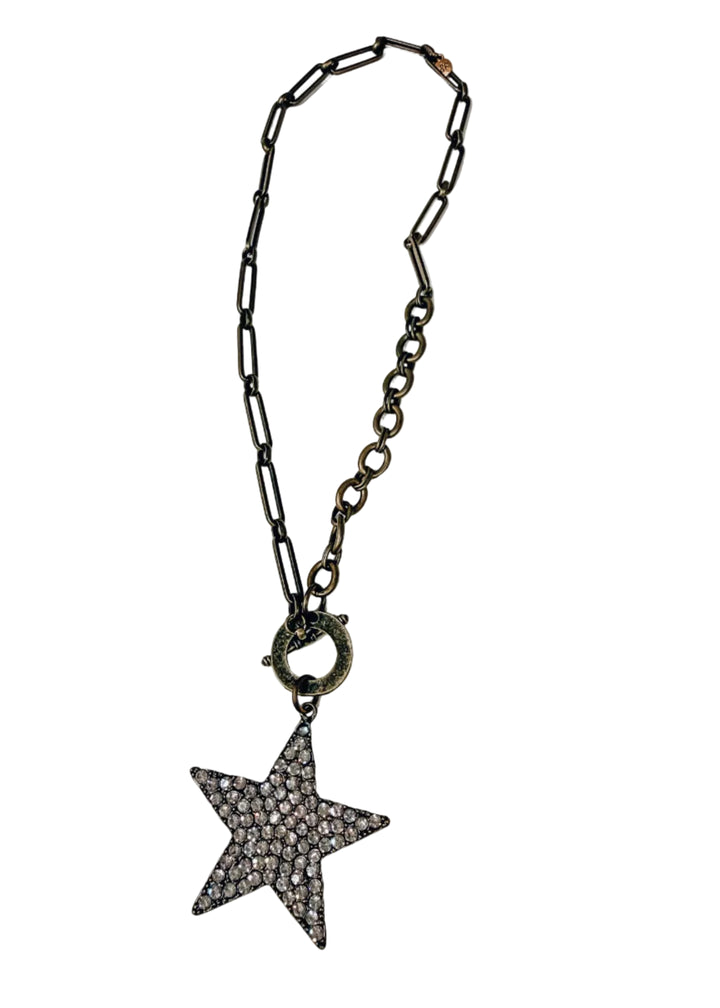 Gold chain necklace with large star pave pendant on white background