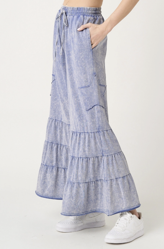 Light blue tiered skirt worn by a person on a white background