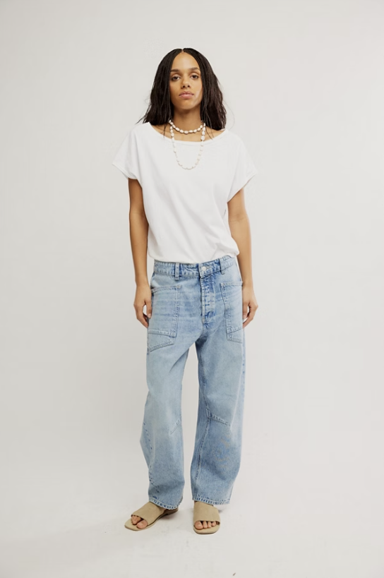 Woman wearing denim jeans and white shirt on white background