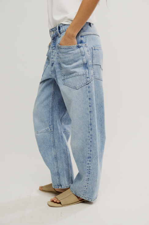 Light blue jeans worn by a person on a white background