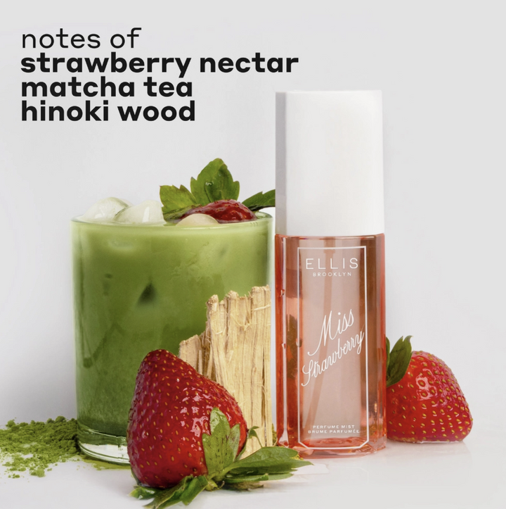 Ellis London Miss Strawberry Eau de Toilette bottle shown next to a glass of matcha tea garnished with a strawberry, with loose matcha powder and wooden sticks on a light gray background. Text at the top reads &