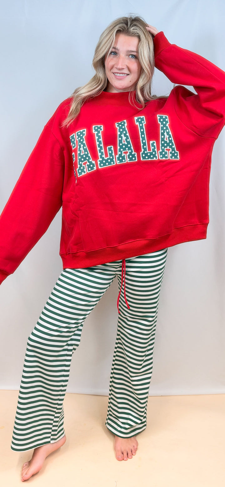 Woman wearing red sweatshirt with &