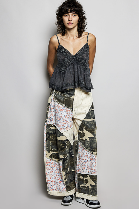 Woman wearing a patchwork skirt with a plain background