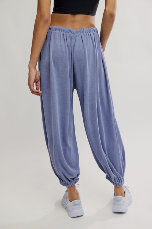 Person wearing blue lounge pants on a plain background