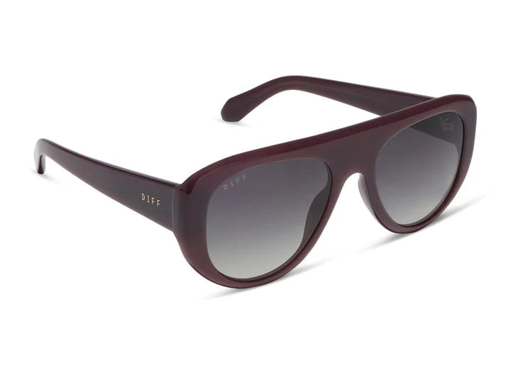 Pair of dark purple sunglasses with grey lenses on white background