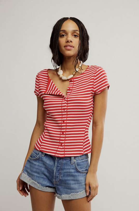 woman wearing red and white stripe cami and blue jeans on white background