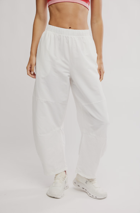 Woman wearing white pants on white background