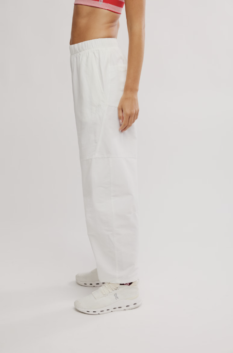 Woman wearing white pants on white background
