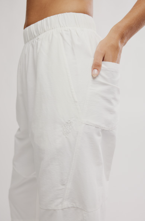Woman wearing white pants on white background