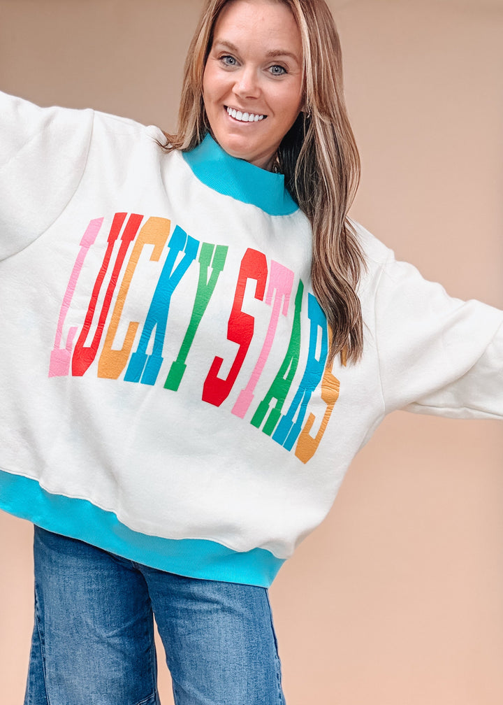 Woman wearing white sweatshirt with &