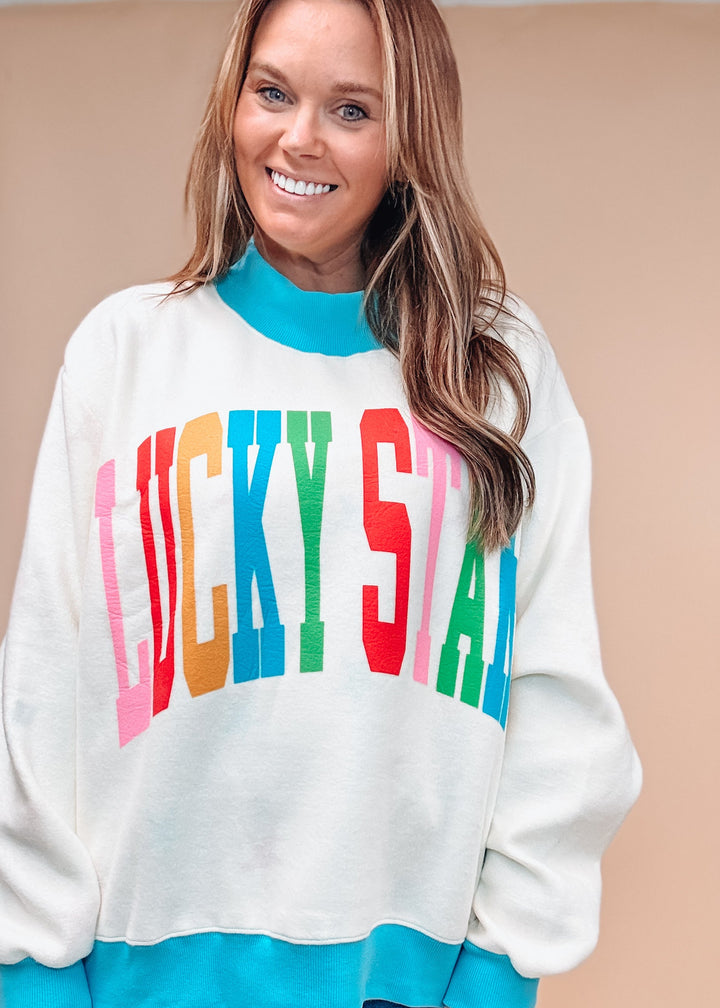 Woman wearing white sweatshirt with &