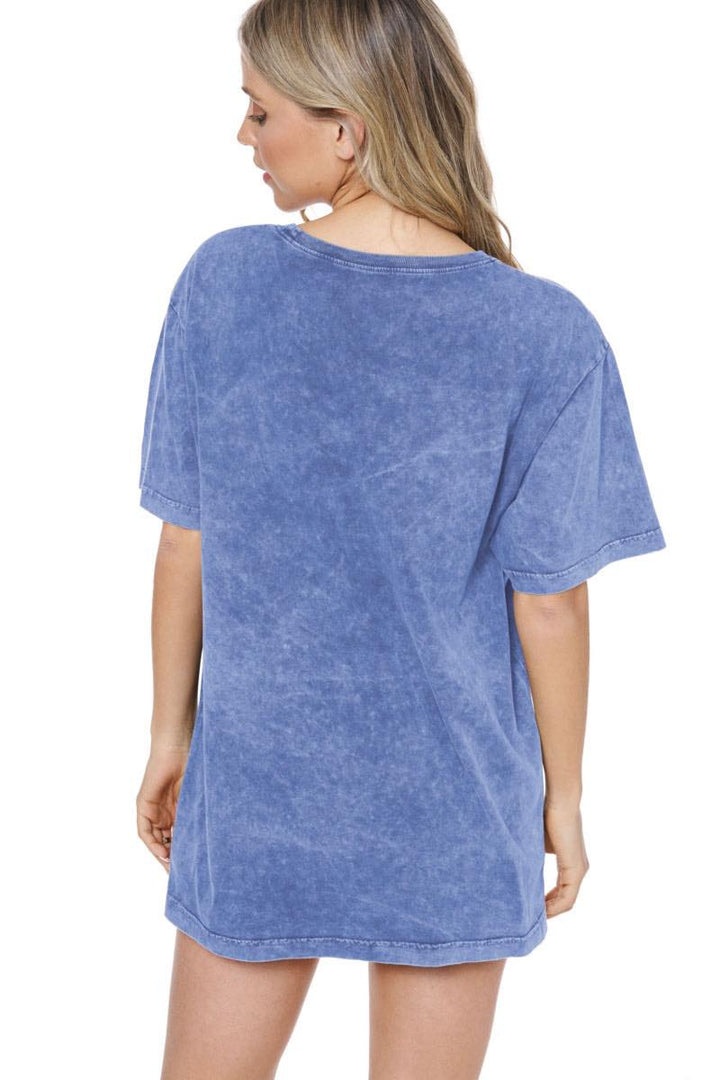 Back of woman wearing blue tee on plain background