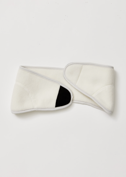 Cream headband with velcro tab on white background