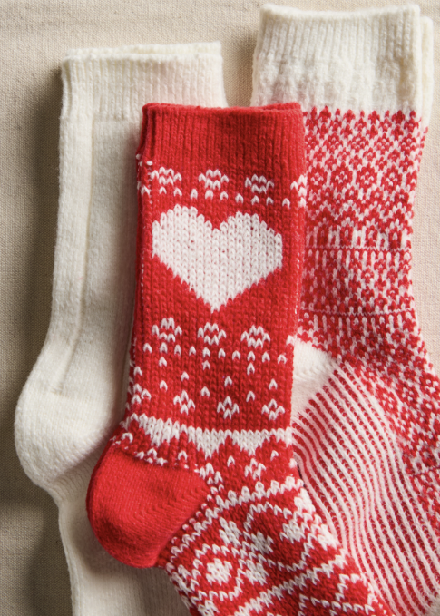 3 pair of red and cream knit socks with heart and nordic designs on cream background
