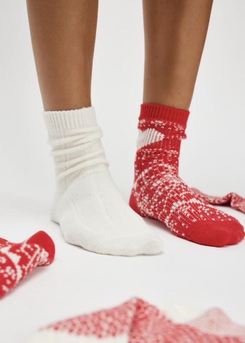 Woman wearing mismatch socks on white background