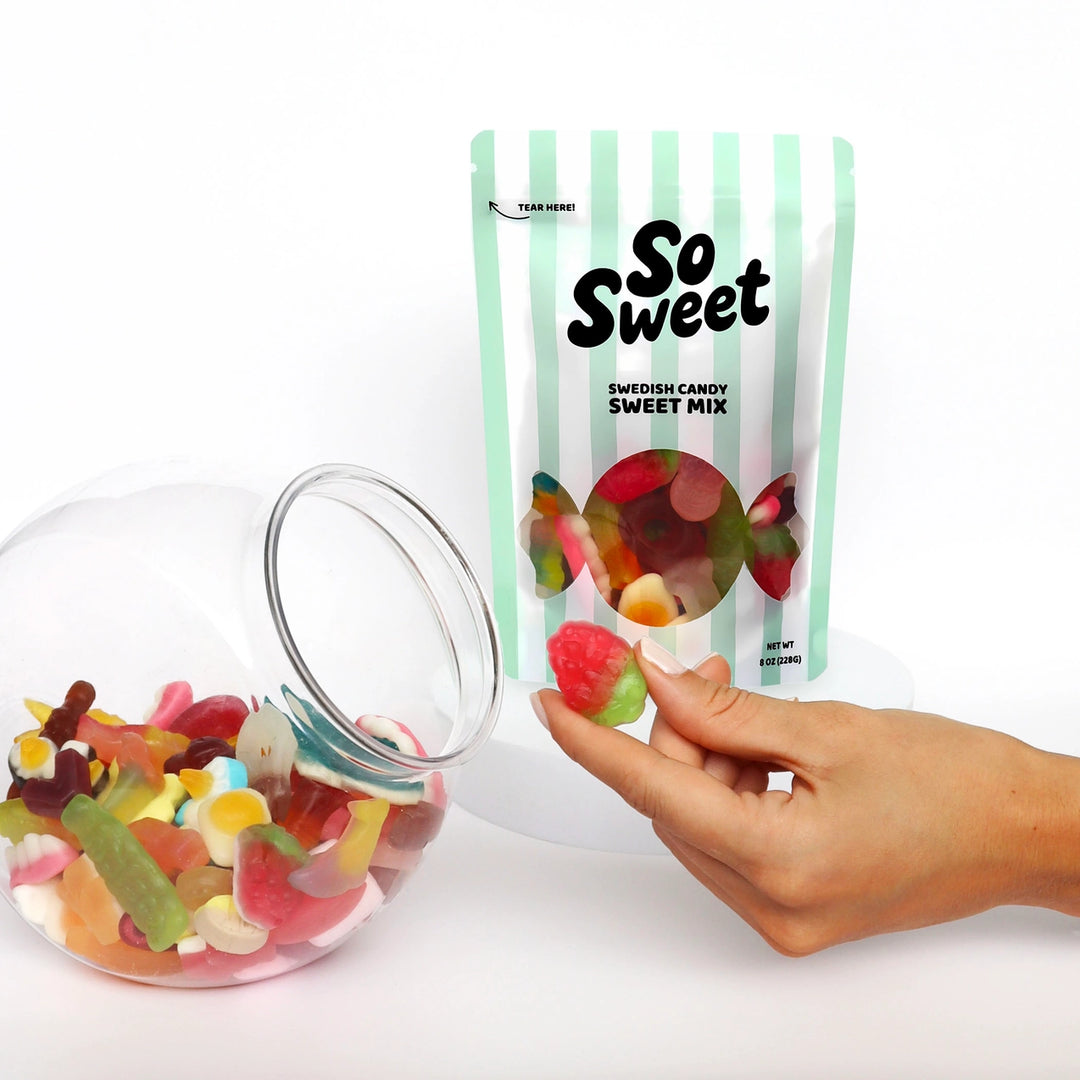 Hand reaching for a gummy candy next to a &