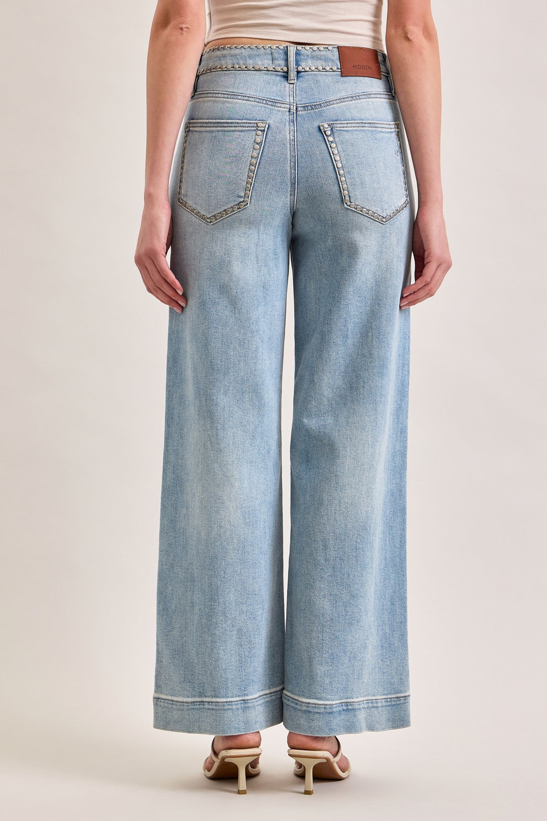 Light blue wide-leg jeans worn by a person on a plain background