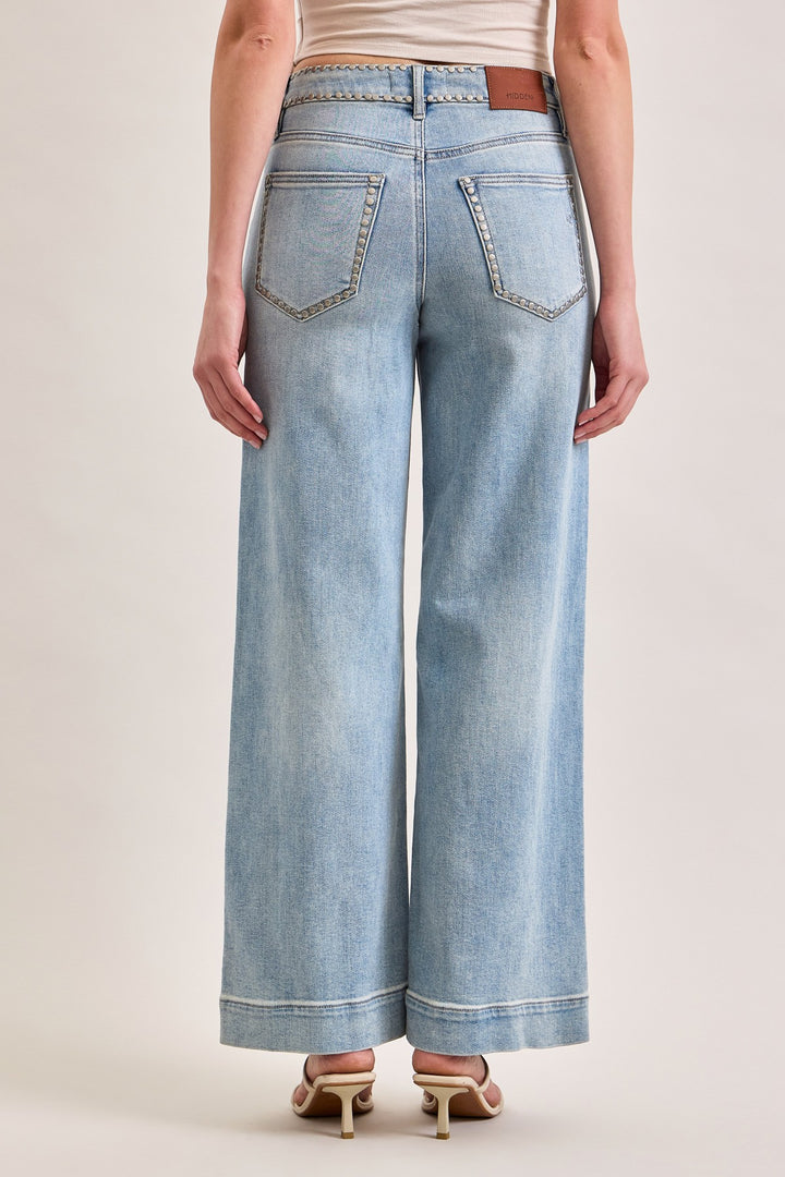 Light blue wide-leg jeans worn by a person on a plain background