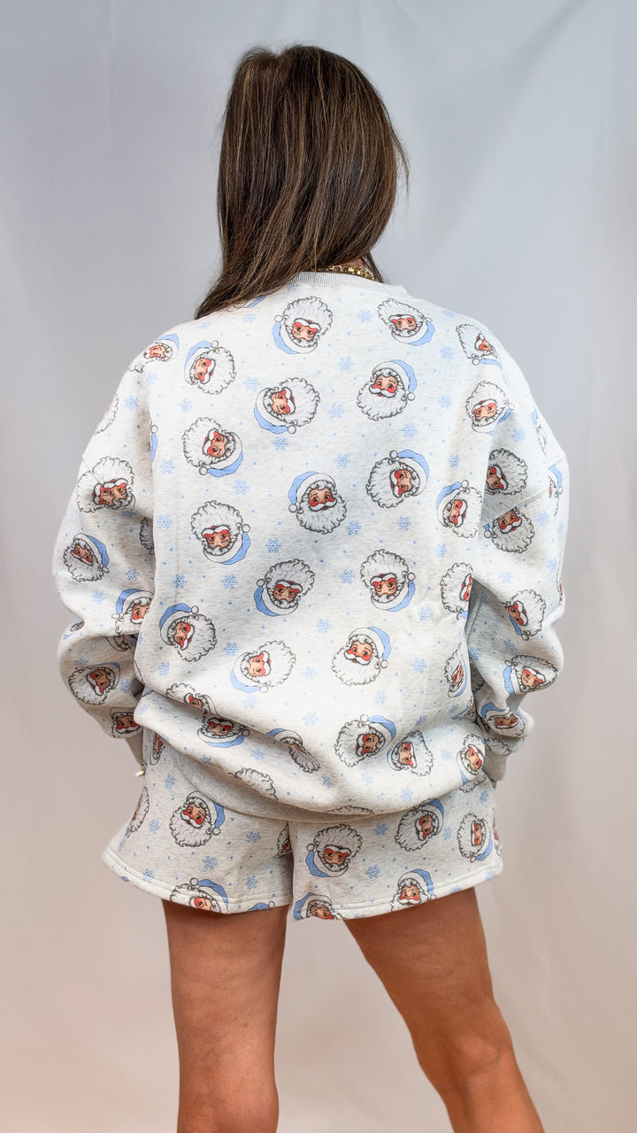 Woman shown from back wearing matching grey set with vintage blue santa faces on plain background