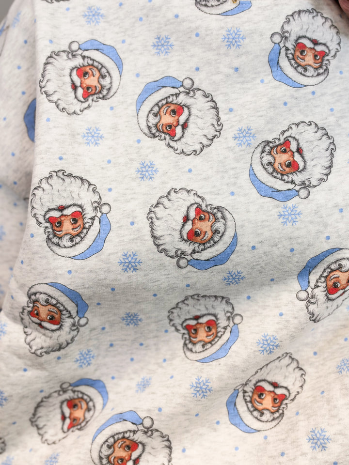Close up of grey sweatshirt with vintage blue santa faces