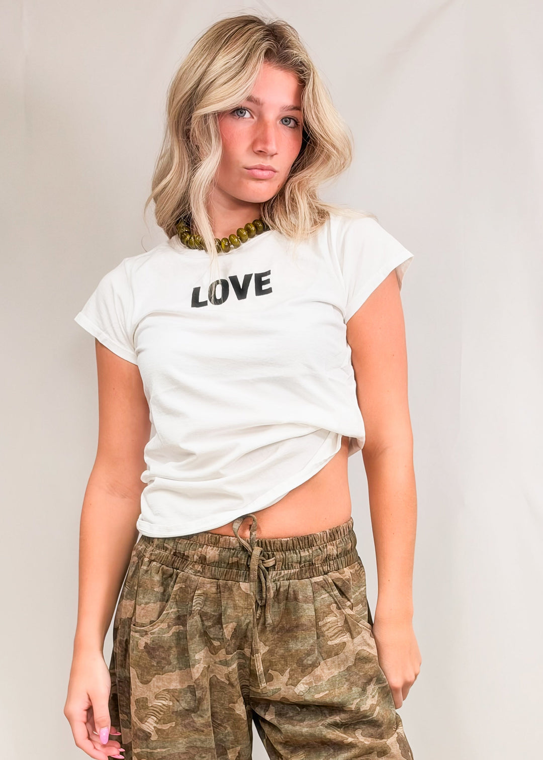 Woman wearing baby tee with &