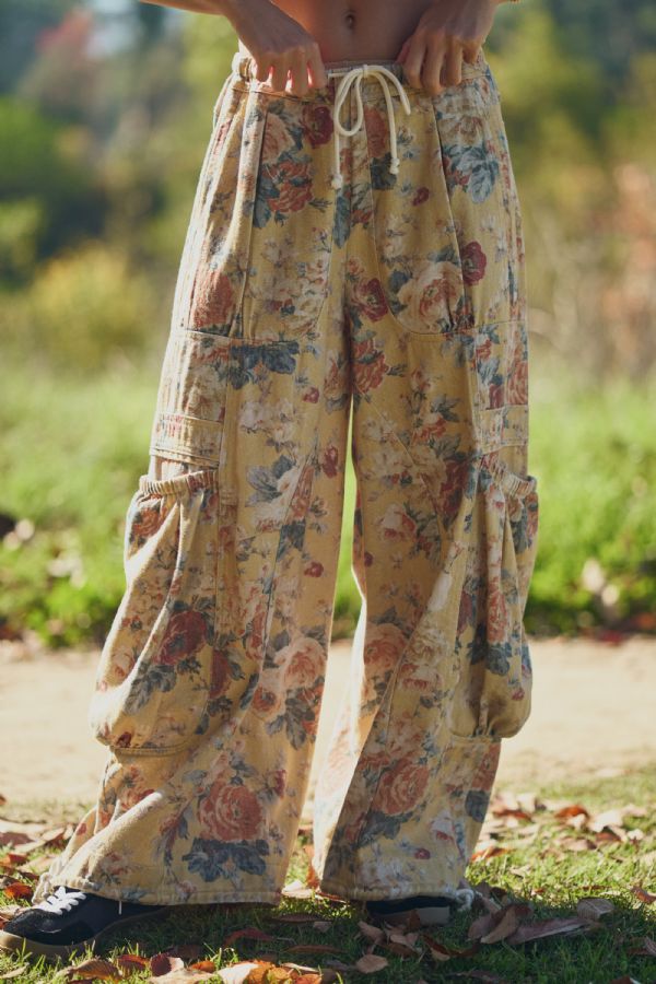 Floral patterned pants worn outdoors with a blurred natural background