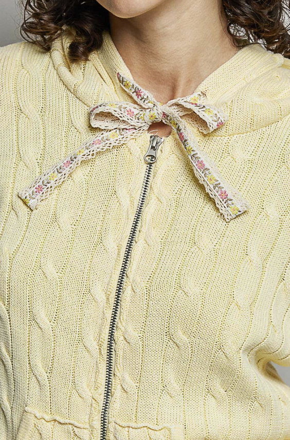 Close up of yellow cable knit sweater