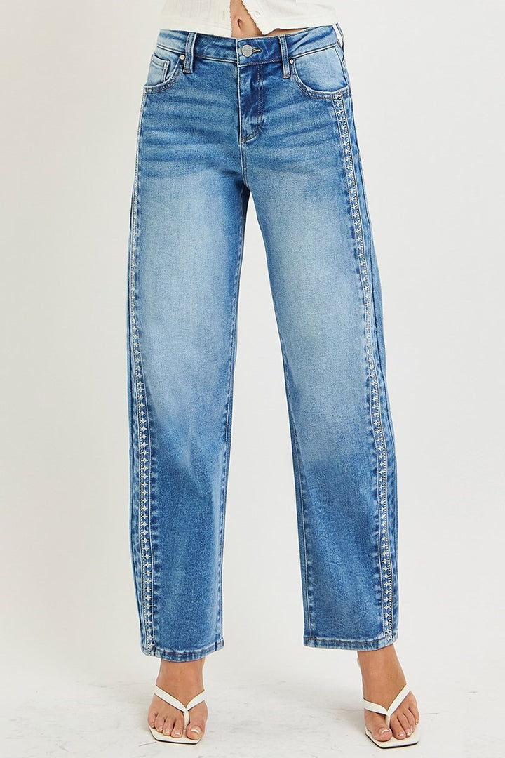 Blue jeans worn by a person on a light gray background