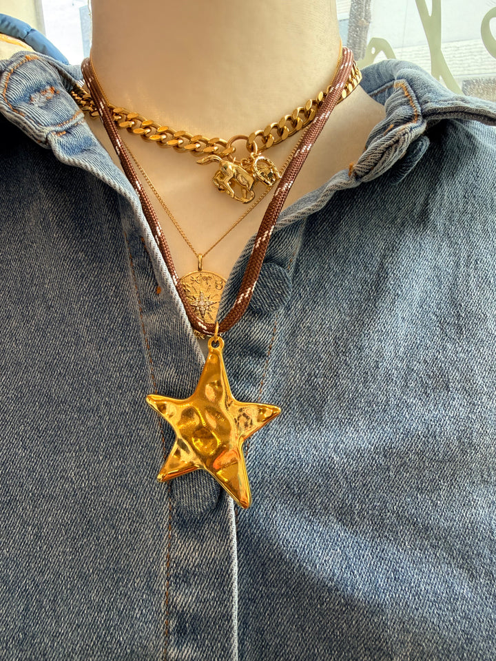 Gold star necklace on brown cord