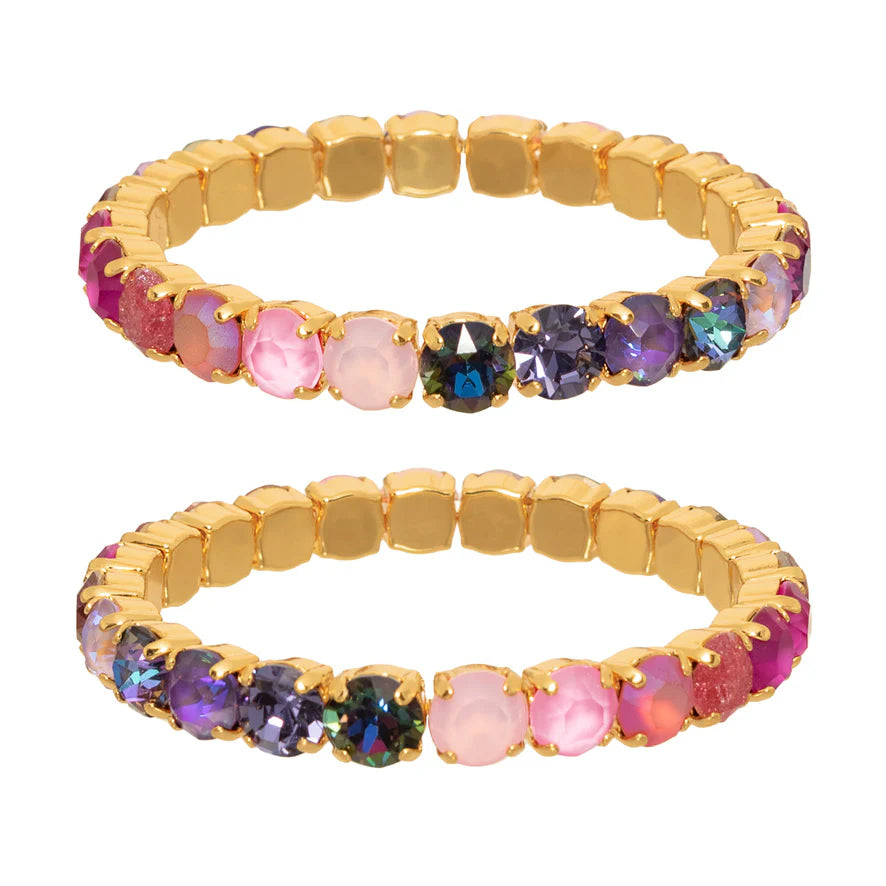 multicolor gemstone and gold bracelet on white background