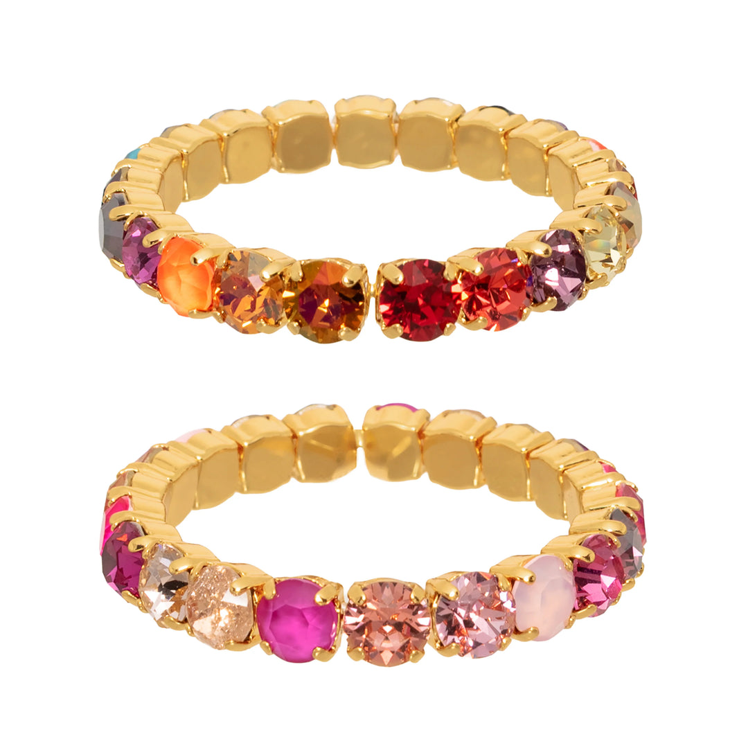 Multicolor gemstone and gold bracelet on white background