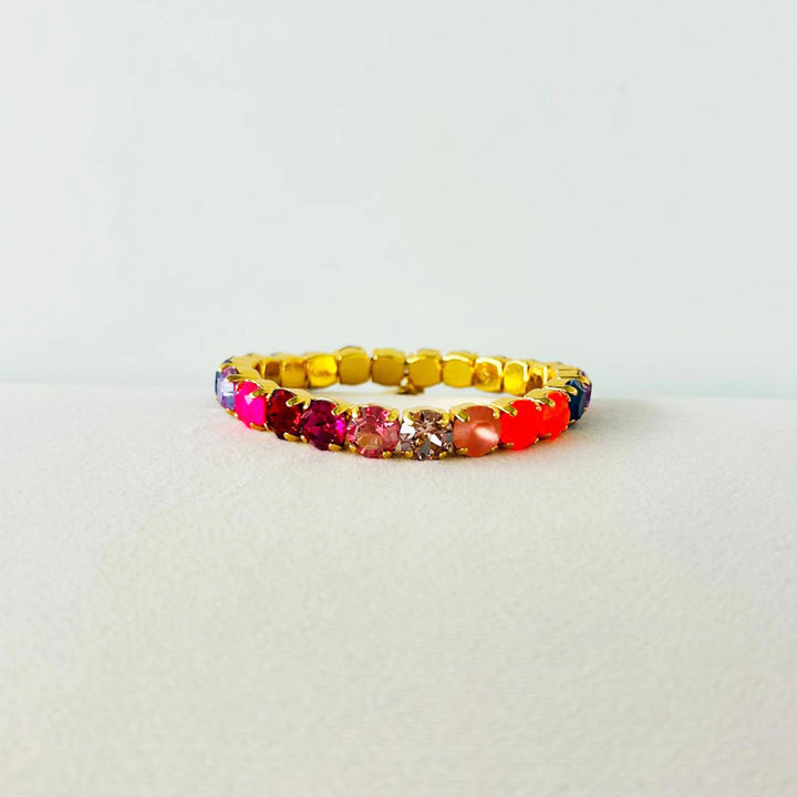 Multicolored beaded bracelet on a light gray background