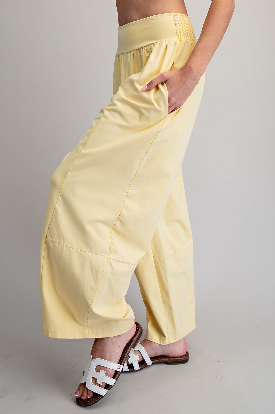 Yellow wide-leg pants worn by a person on a plain background